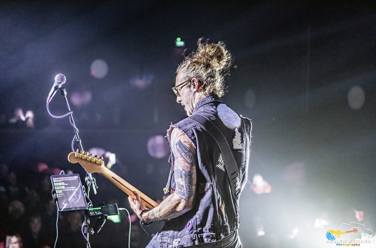 Alex playing guitar live