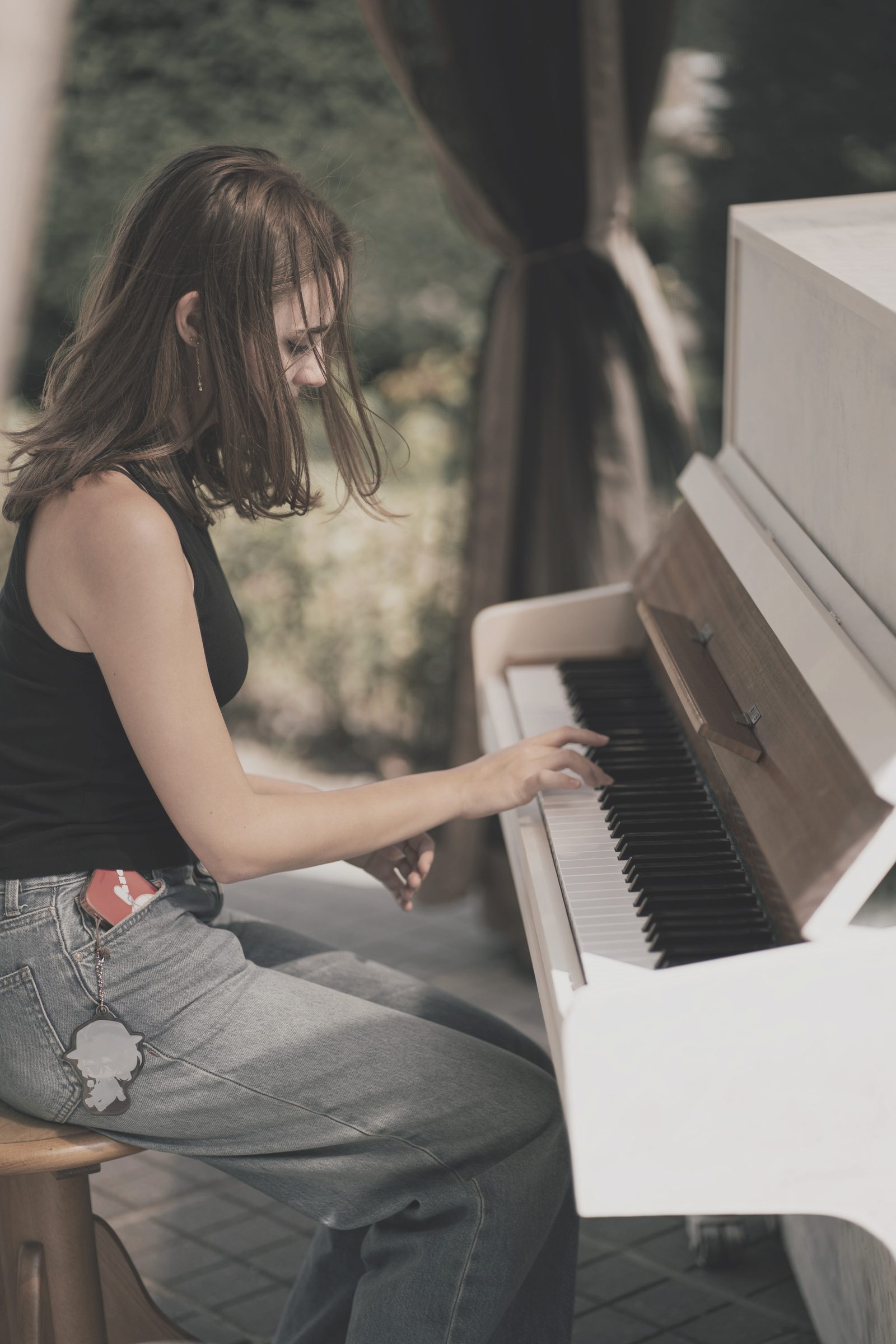 Piano student playing an upright piano