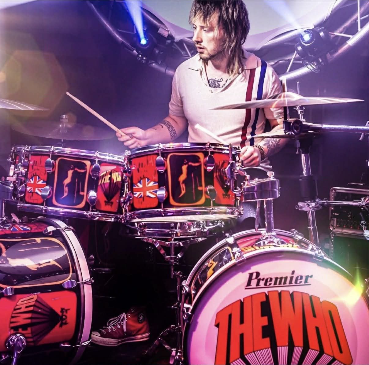Reuben behind the drum kit on stage